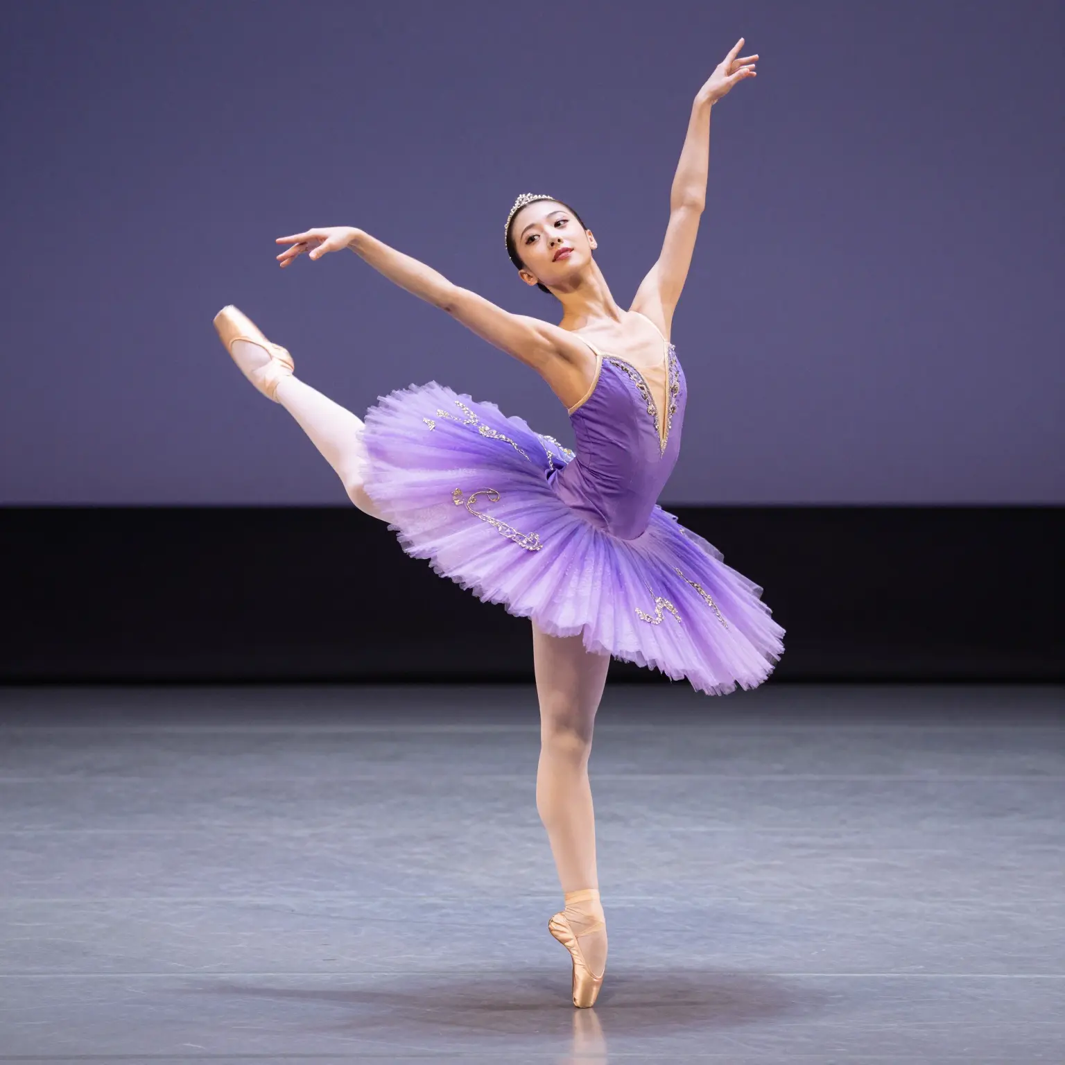 A graceful dancer wearing a flowing purple tutu outfit